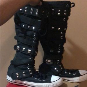 Slightly worn mega high top converse .